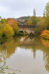 Obraz premium Small stone arched bridge across the Alzette River in the Grund, lower part of Luxembourg city, Luxembourg. Scenic autumn landscape