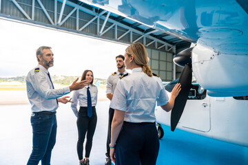 Aviation instructor teaching student pilots about airplane engine © unai