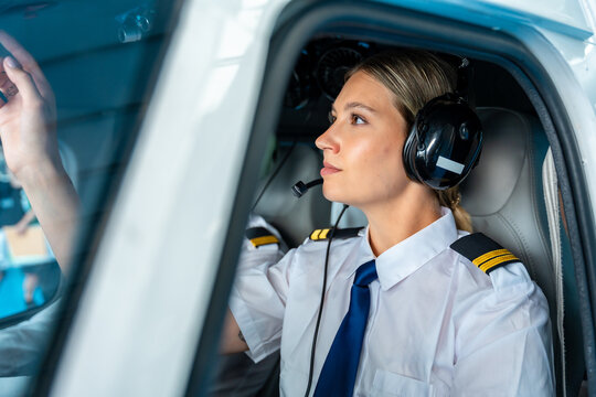 Female pilot preparing aircraft for flight operations