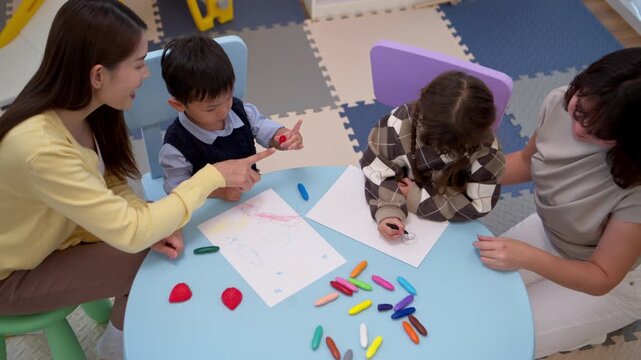 Teacher and parent guiding children in an art activity, promoting learning and creative thinking skills