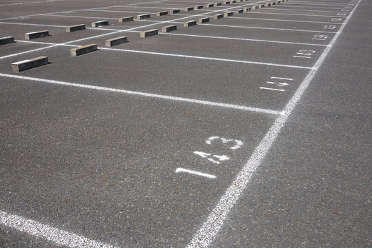 Ooutdoor parking lot with numbered spaces and white lines.（駐車場）2