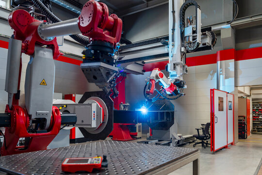 Automated industrial robot welding metal in a modern factory