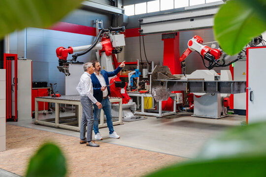 Engineers discussing automation technology in a factory