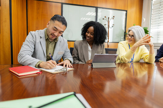 Factory professional signing contract during office meeting