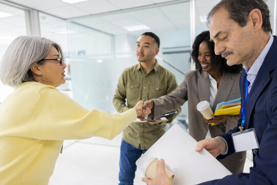 Engineer shaking hands during teamwork meeting at industrial office
