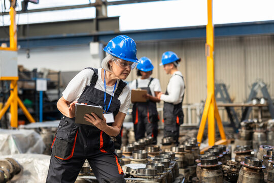Factory supervisor using tablet indoors in manufacturing warehouse