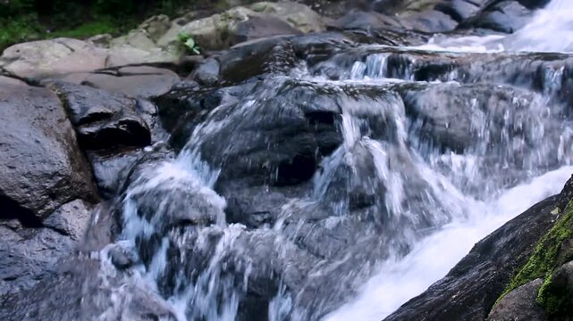 Mountain Stream Flowing Over Wet Rocks in Tropical Forest &ndash; Natural Freshwater Cascade Close Up