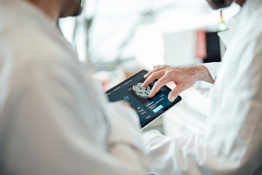 Examining brain scan on digital tablet in medical laboratory