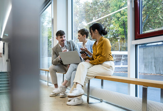Business team collaborating and discussing ideas in modern office