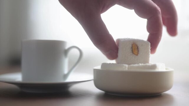 Close-up of traditional Turkish coffee served with delicious Turkish delight lokum on an elegant platter