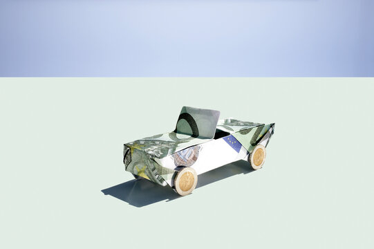 Origami car folded from euro note for savings and investment