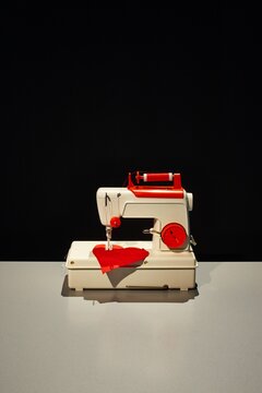 Vintage sewing machine repairing a red heart shape
