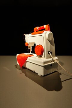 Vintage toy sewing machine repairing a red broken heart shape