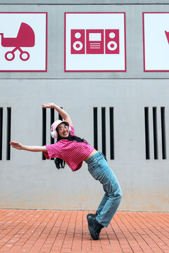 Female dancer leaning backwards to music on a city street