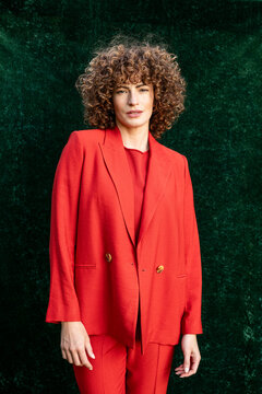 Fashion model posing in orange blazer outdoors
