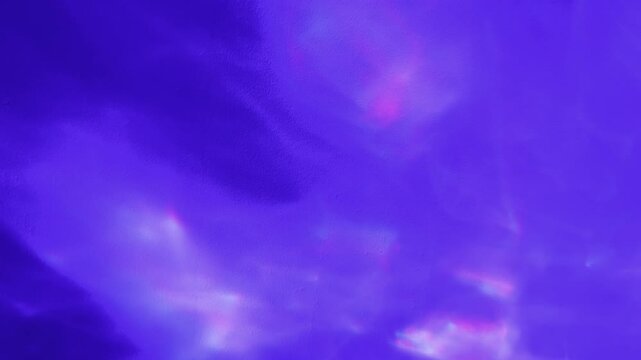 caustic prism shimmer dances across violet textured surface creating ethereal cinematic loop