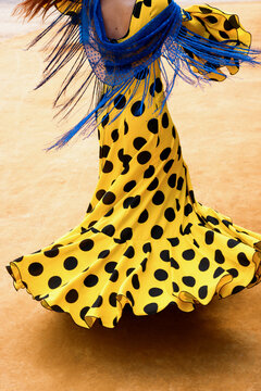 Flamenco dress with polka dots twirling at Feria de Abril in Spain