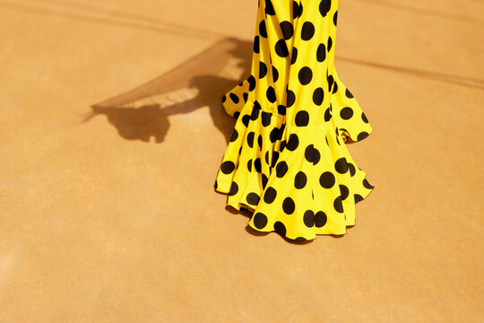Detail of yellow flamenco dress with polka dots at Feria de Abril
