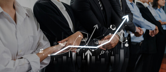 A diverse business team stands united with a growth chart overlay, symbolizing collaboration and progress in achieving financial success and strategic goals. Trope © InfiniteFlow