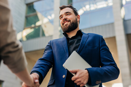 Smiling businessman shaking hands during recruitment meeting