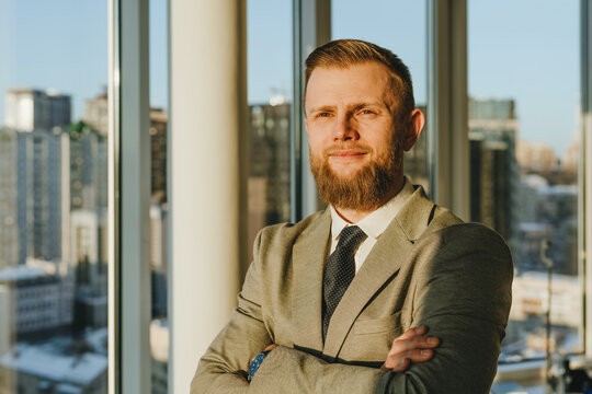 Confident businessman in office with urban skyline view
