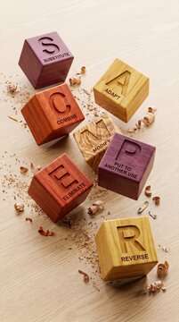 SCAMPER brainstorming technique concept with seven wooden blocks displaying letters and words on a light wood surface with shavings