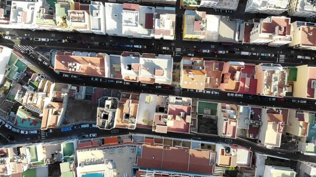 Top down drone view over rooftops and narrow streets of Los Cristianos, Tenerife, Canary Islands, Spain