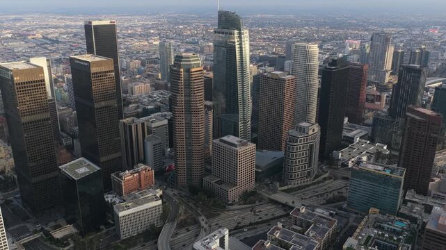Los Angeles cityscape featuring Financial District skyscrapers, distant urban neighborhood expansion revealing urban sprawl in sunny Southern California