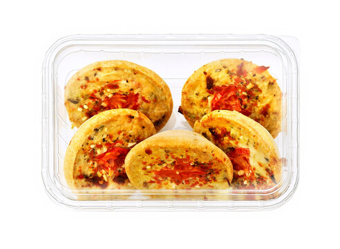 Various types of quiches in plastic tray, isolated on white