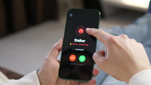 Anxious person receives a restricted call from Stalker on their smartphone. High-impact visual for harassment awareness, personal safety, and social documentary videos. Ideal for digital security and