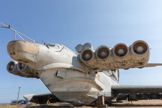 Large Soviet-era Lun-class ekranoplan ground effect aircraft displayed on the Caspian Sea coast in Derbent, Dagestan, Russia, under clear blue sky, wide angle view