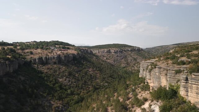 4K 10-bit drone shot flying forward through Tokatli Canyon with the Crystal Glass Terrace observatory in the background in Safranbolu, Turkey