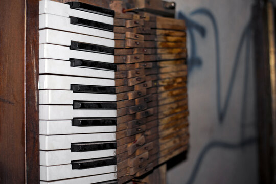 black and white keys of an old piano. details of a musical instrument. close-up. disassembled, broken keyboard instrument, piano or grand piano, wood parts. vintage, retro. musical instrument