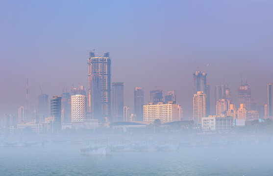Air pollution concept - Modern highrise rich buildings and poor slums at day - Mumbai, india 