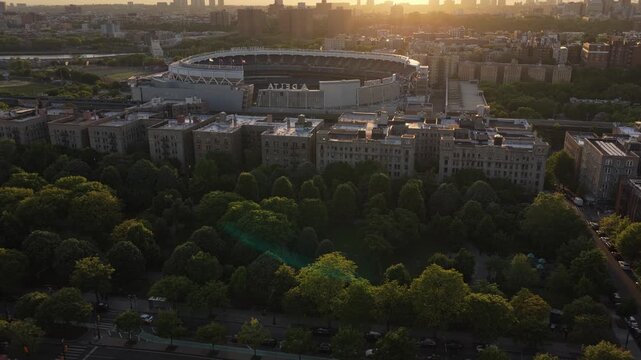Yankee Stadium revealing with South Bronx cityscape during golden hour sunset in New York City in the most famous city of America