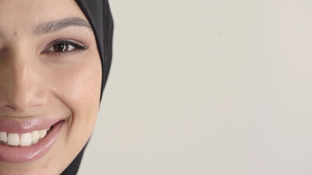 Teeth whitening, face and muslim woman in studio with dental, oral care and smile for hygiene. Cropped, mouth and orthodontics with person, mockup space and portrait for veneers on white background