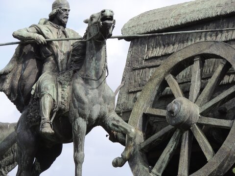 Detailed bronze sculpture of a gaucho warrior on horseback beside a wagon wheel, symbolizing South American frontier heritage in Montevideo, Uruguay.