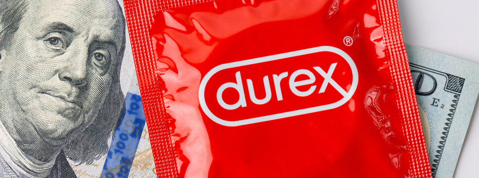 An image of a red Durex condom package along with dollar bills.