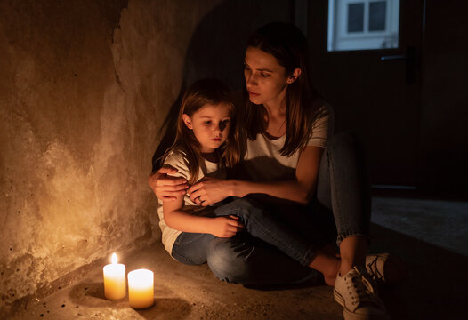 Young Mother and Daughter Taking Shelter in Basement During Air Raid