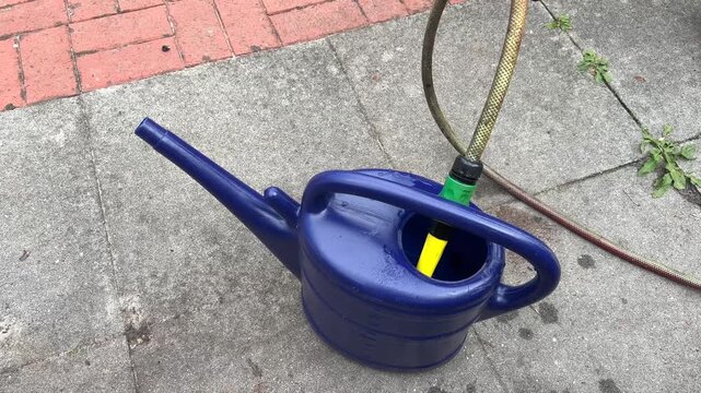 Filling a garden watering can