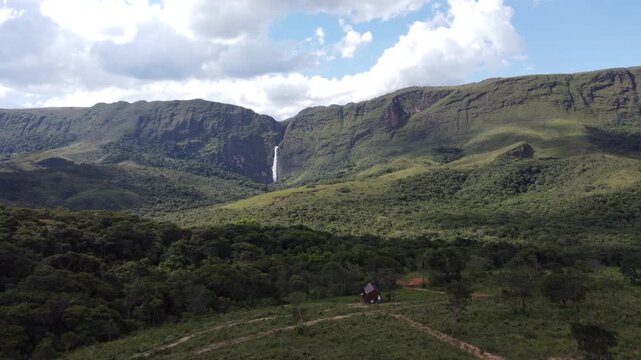 Aerial views of Casca D&rsquo;Anta Waterfall in Serra da Canastra National Park, Brazil, featuring towering cliffs, cascading water, rugged landscapes, and the pristine beauty of one of Brazil&rsquo;s most iconic