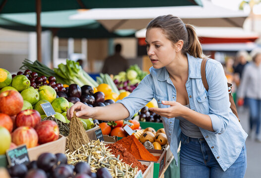 Young Woman Buying Spices at Local Farmers Market