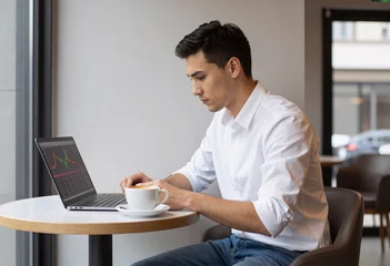 Entrepreneur checking stock market graphs in modern cafe © Outsiderzone