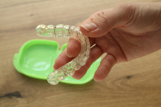 Photo of a people holding a dental mouth guard. Treatment with a splint. Health and medicine. Bruxism prevention. Teeth protection and alignment. Jaw pain. Dentistry and orthodontics. Teeth grinding.