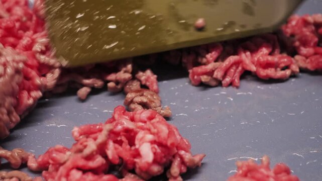 Ground beef frying in a pan, close-up of the cooking process with browning meat and rich texture. High quality 4k footage