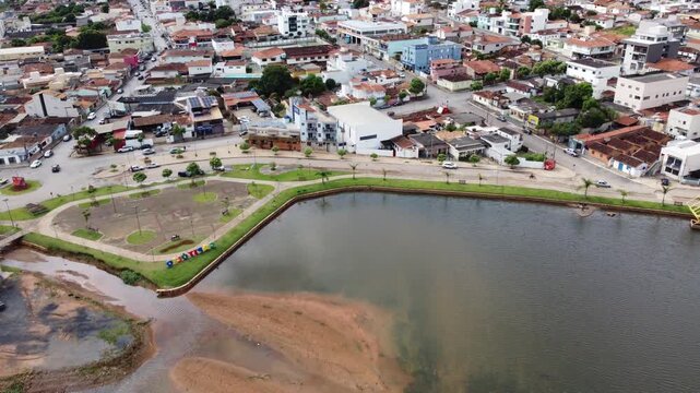 Aerial view of Capit&oacute;lio, Brazil, featuring the city sign, urban landscape, and the famous Furnas Lake surrounded by rolling hills, scenic countryside, and natural beauty.