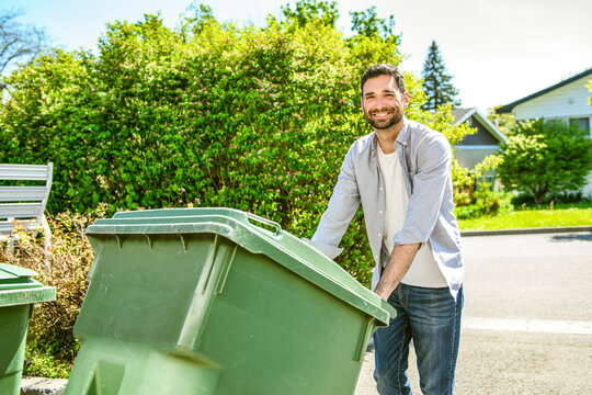A young man prepares to take out the trash