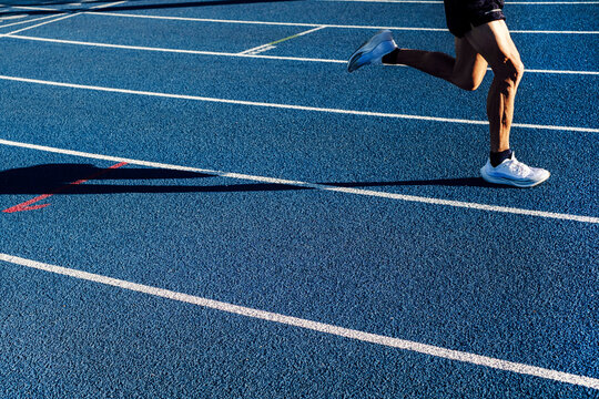 Mature athlete running on track