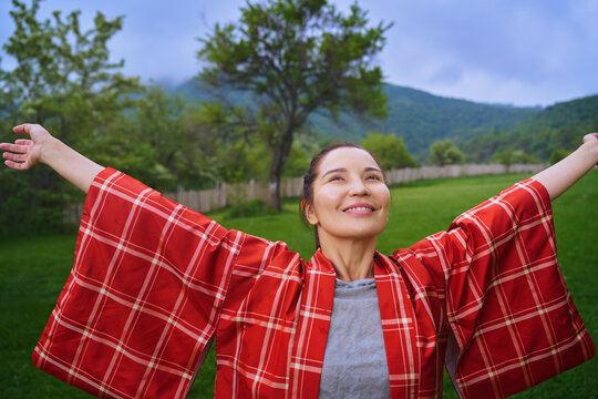 Smiling woman stretching in the countryside enjoying nature