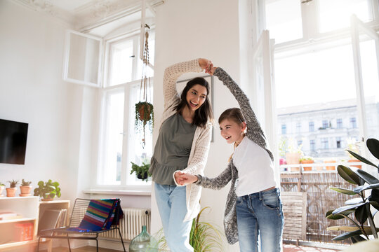 Happy mother with daughter at home